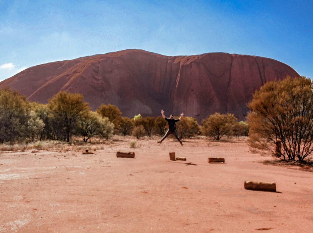 Jumping for joy at seeing Uluru up close